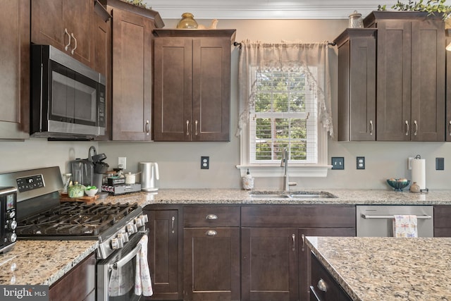 500 Prince George Dr, Lancaster, PA 17601 - kitchen featuring appliances with stainless steel finishes, a sink, dark brown cabinets, light stone counters, and ornamental molding