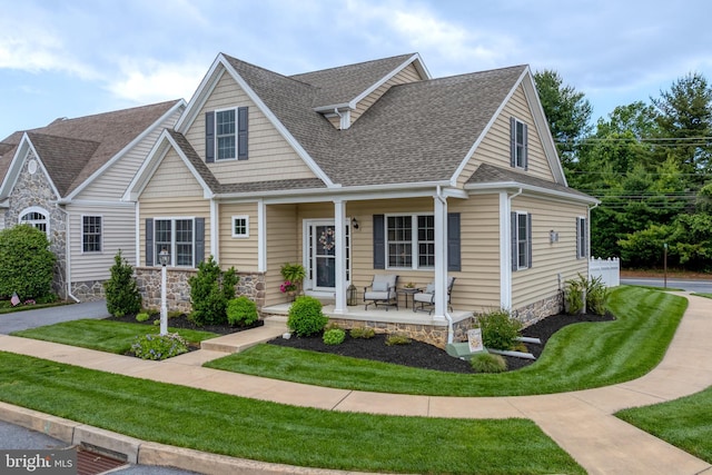 500 Prince George Dr, Lancaster, PA 17601 - view of front of house featuring covered porch, roof with shingles, a front yard, and stone siding