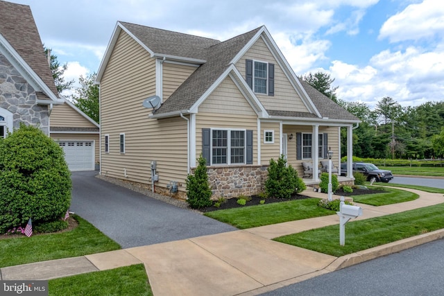 500 Prince George Dr, Lancaster, PA 17601 - view of front facade featuring driveway, roof with shingles, an outbuilding, covered porch, and stone siding