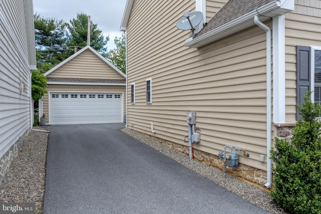 500 Prince George Dr, Lancaster, PA 17601 - view of home's exterior with an outdoor structure, roof with shingles, and a garage