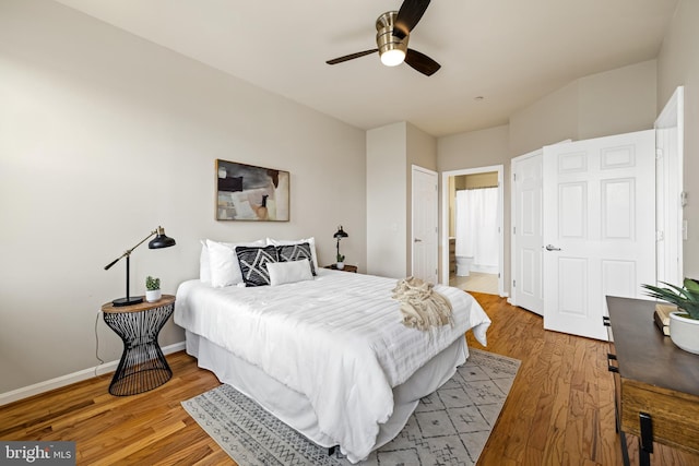 23 Pierside Dr Unit 429, Baltimore, MD 21230 - bedroom featuring wood finished floors, baseboards, ensuite bathroom, and ceiling fan
