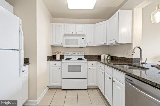 23 Pierside Dr Unit 429, Baltimore, MD 21230 - kitchen featuring white appliances, a sink, light tile patterned flooring, white cabinets, and dark stone countertops