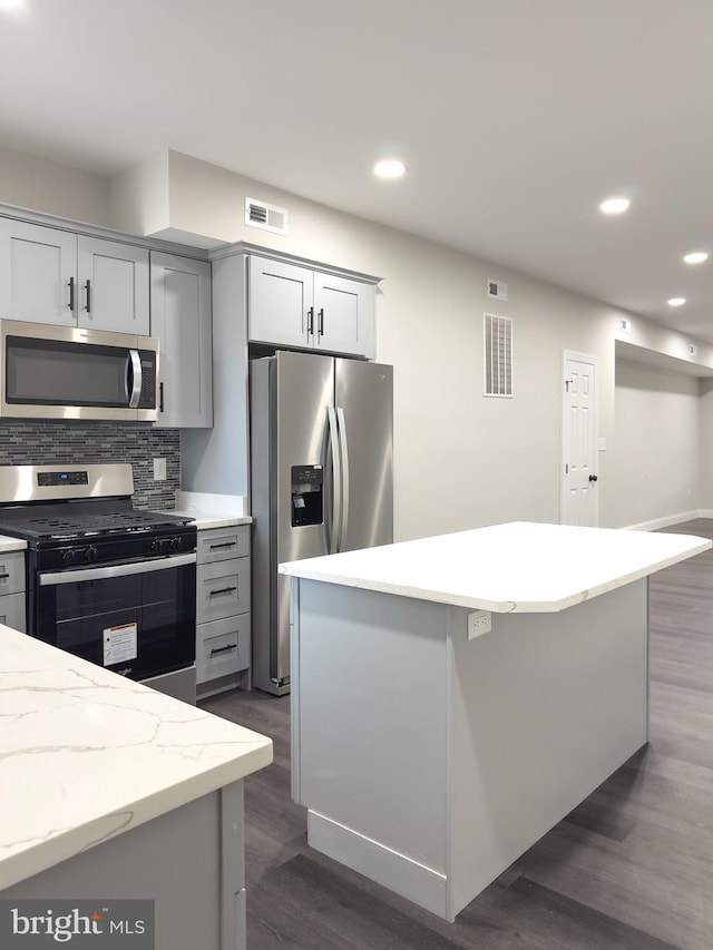 1736 E 30th St, Baltimore, MD 21218 - kitchen featuring stainless steel appliances, recessed lighting, backsplash, dark wood-type flooring, and a kitchen island