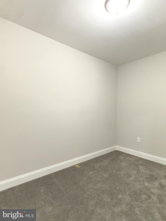 1736 E 30th St, Baltimore, MD 21218 - unfurnished room with dark carpet and baseboards