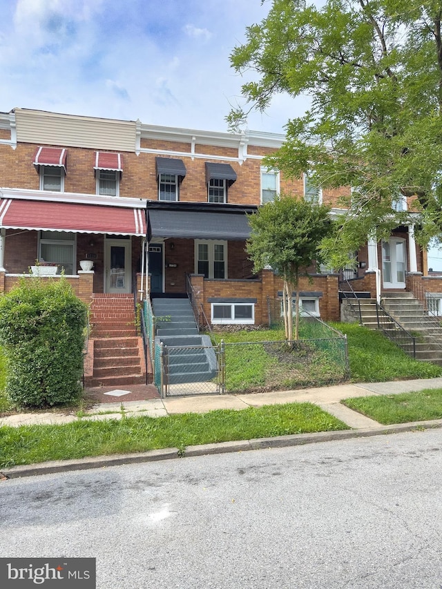 1736 E 30th St, Baltimore, MD 21218 - view of property with stairway, brick siding, and a porch
