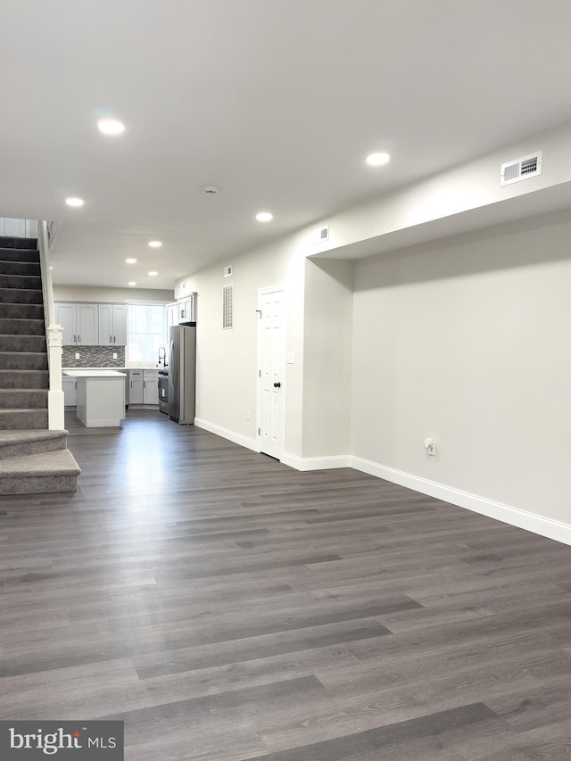 1736 E 30th St, Baltimore, MD 21218 - unfurnished living room with recessed lighting, dark wood-type flooring, and stairs