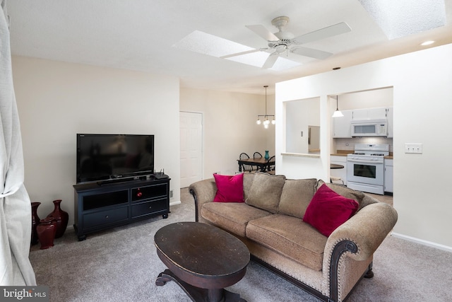 82 Cheverny Ct, Hamilton, NJ 08619 - living room with a chandelier, light carpet, a ceiling fan, baseboards, and a skylight