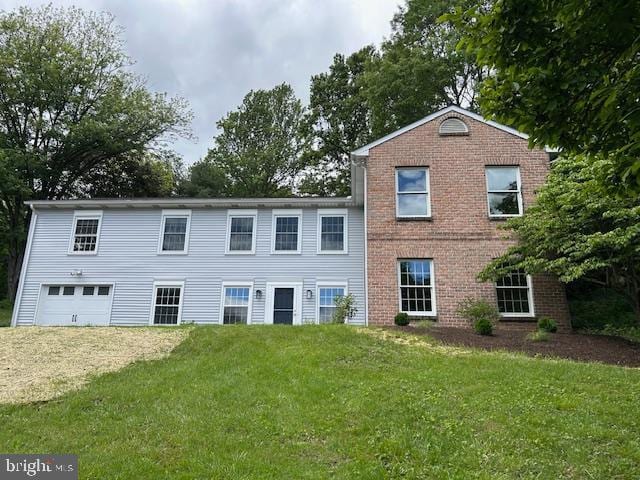 1866 Miller Rd, Hummelstown, PA 17036 - view of front of house with dirt driveway, a front lawn, an attached garage, and brick siding