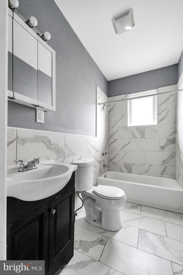 36 N Millbourne Ave, Upper Darby, PA 19082 - full bathroom featuring toilet, vanity, tub / shower combination, wainscoting, and tile walls