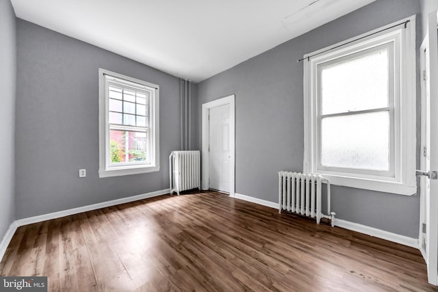 36 N Millbourne Ave, Upper Darby, PA 19082 - unfurnished room with radiator heating unit, dark wood-style flooring, and baseboards