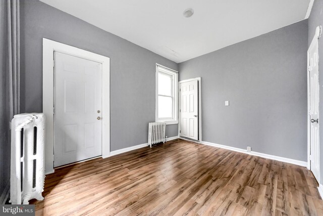 36 N Millbourne Ave, Upper Darby, PA 19082 - unfurnished bedroom with radiator heating unit, wood finished floors, and baseboards