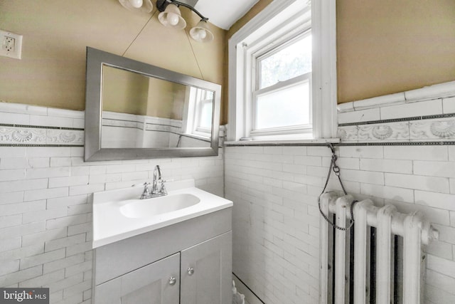 36 N Millbourne Ave, Upper Darby, PA 19082 - bathroom with radiator heating unit, tile walls, vanity, and wainscoting