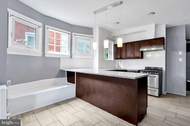 36 N Millbourne Ave, Upper Darby, PA 19082 - kitchen featuring stainless steel gas range oven, under cabinet range hood, a peninsula, and plenty of natural light
