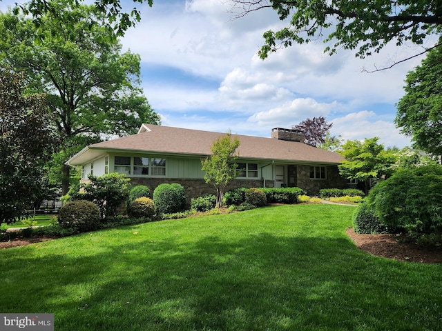 1545 Farr Rd, Wyomissing, PA 19610 - view of front of home with stone siding, a chimney, and a front lawn