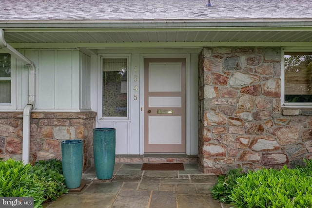 1545 Farr Rd, Wyomissing, PA 19610 - property entrance featuring stone siding, roof with shingles, and board and batten siding