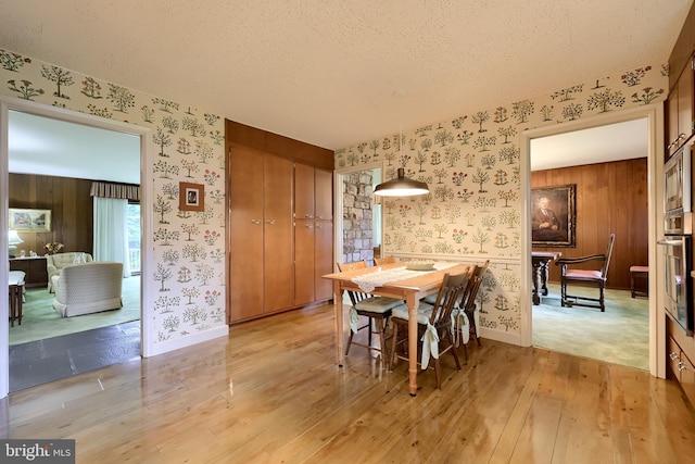 1545 Farr Rd, Wyomissing, PA 19610 - dining space with wallpapered walls, a textured ceiling, light wood-type flooring, and baseboards