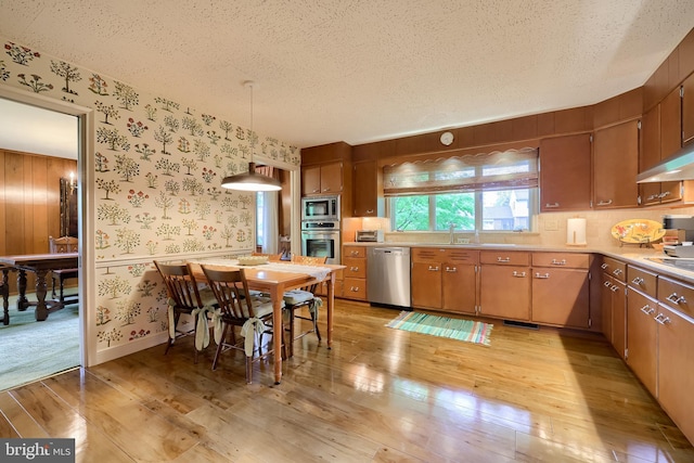 1545 Farr Rd, Wyomissing, PA 19610 - kitchen with appliances with stainless steel finishes, wallpapered walls, light wood finished floors, a textured ceiling, and light countertops