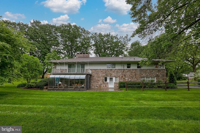 1545 Farr Rd, Wyomissing, PA 19610 - back of house with stone siding, a sunroom, and a chimney