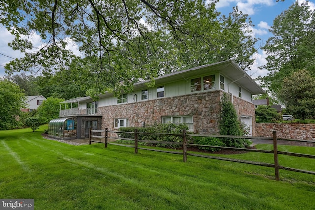 1545 Farr Rd, Wyomissing, PA 19610 - rear view of house with stone siding, a garage, and driveway