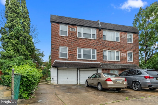 210 Erica Ter, Philadelphia, PA 19116 - townhome / multi-family property featuring a garage, brick siding, and concrete driveway