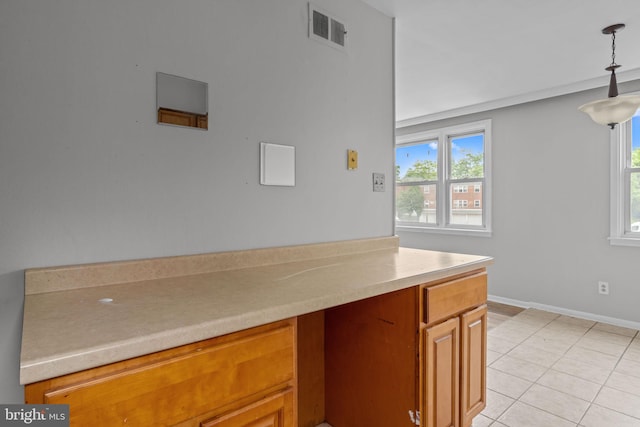 210 Erica Ter, Philadelphia, PA 19116 - kitchen with healthy amount of natural light, light countertops, brown cabinets, and hanging light fixtures
