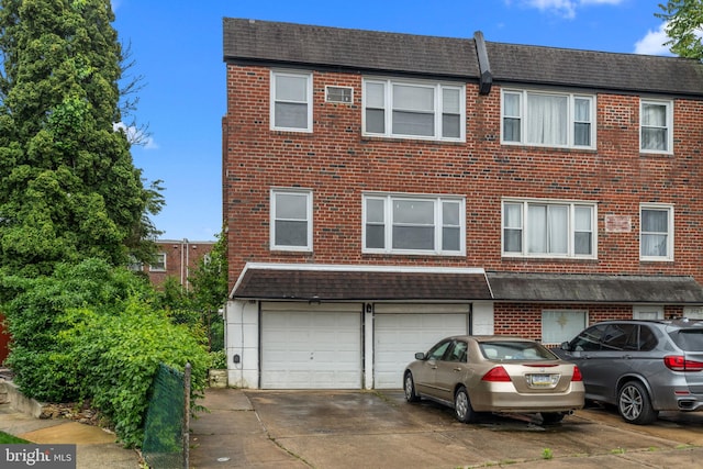 210 Erica Ter, Philadelphia, PA 19116 - multi unit property featuring a garage, driveway, and brick siding