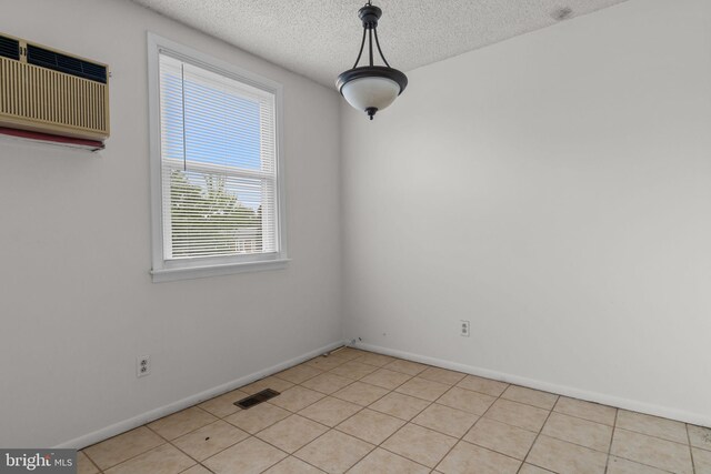 210 Erica Ter, Philadelphia, PA 19116 - spare room with a wall mounted AC, a textured ceiling, baseboards, and light tile patterned flooring