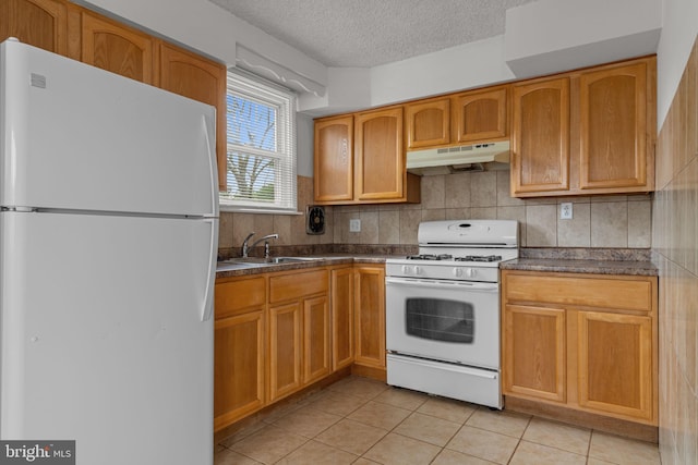 210 Erica Ter, Philadelphia, PA 19116 - kitchen with white appliances, under cabinet range hood, a sink, dark countertops, and a textured ceiling