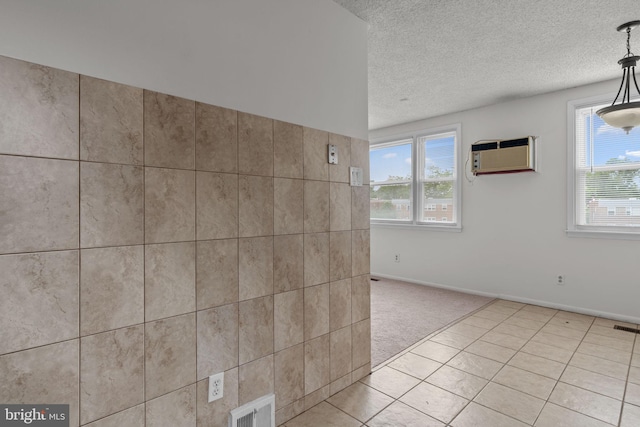 210 Erica Ter, Philadelphia, PA 19116 - spare room featuring a textured ceiling, light colored carpet, light tile patterned floors, baseboards, and a wall unit AC
