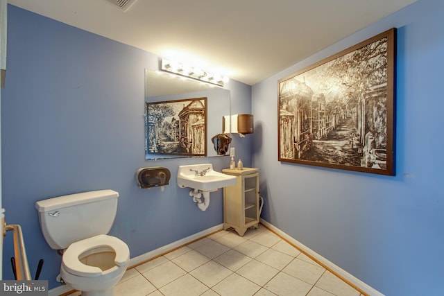 12133 Neale Sound Dr, Cobb Island, MD 20625 - bathroom with toilet, tile patterned floors, baseboards, and a sink