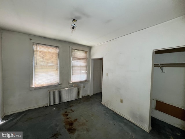 510 62nd Ave, Capitol Heights, MD 20743 - unfurnished bedroom with radiator heating unit, concrete flooring, a closet, and baseboards