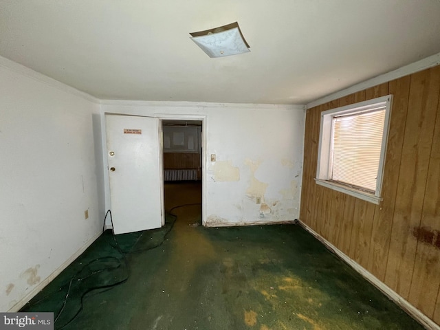 510 62nd Ave, Capitol Heights, MD 20743 - unfurnished room with wooden walls, baseboards, radiator heating unit, and concrete floors