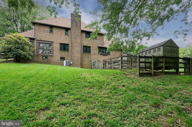 7423 Round Hill Rd, Frederick, MD 21702 - rear view of property featuring brick siding, a chimney, and central AC unit