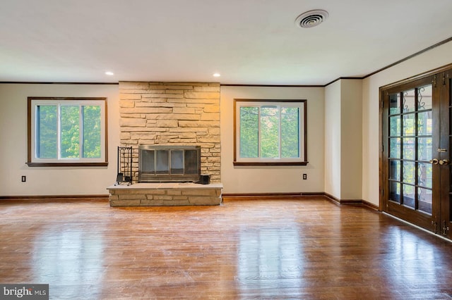7423 Round Hill Rd, Frederick, MD 21702 - unfurnished living room with crown molding, wood finished floors, a stone fireplace, baseboards, and french doors