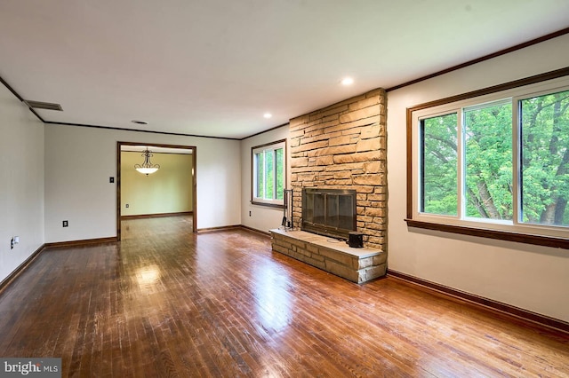 7423 Round Hill Rd, Frederick, MD 21702 - unfurnished living room with wood-type flooring, crown molding, baseboards, a stone fireplace, and recessed lighting