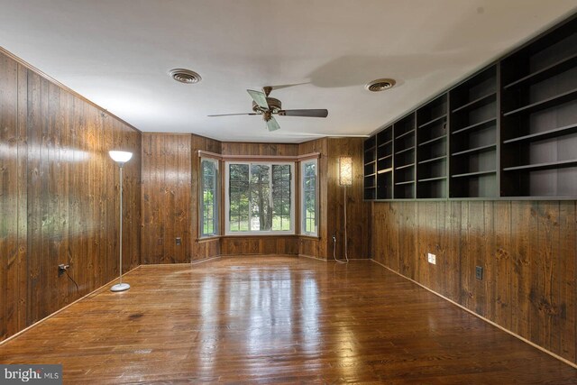 7423 Round Hill Rd, Frederick, MD 21702 - unfurnished room with wood-type flooring, wooden walls, and ceiling fan