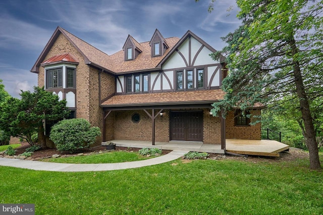 7423 Round Hill Rd, Frederick, MD 21702 - tudor home with a front lawn, stucco siding, brick siding, and covered porch