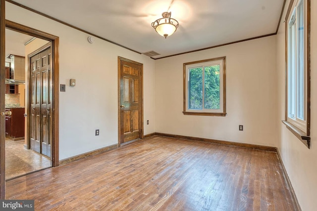 7423 Round Hill Rd, Frederick, MD 21702 - spare room featuring light wood finished floors, baseboards, and crown molding