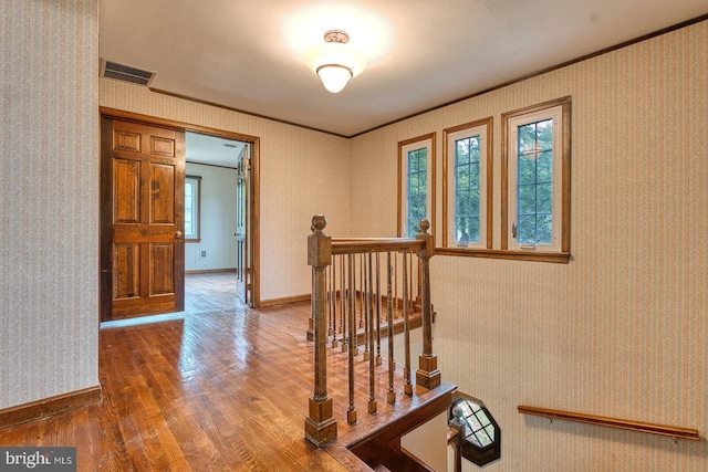 7423 Round Hill Rd, Frederick, MD 21702 - hallway featuring wood finished floors, crown molding, an upstairs landing, baseboards, and wallpapered walls