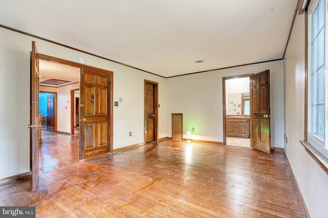7423 Round Hill Rd, Frederick, MD 21702 - unfurnished room featuring light wood-style flooring, crown molding, baseboards, and a sink