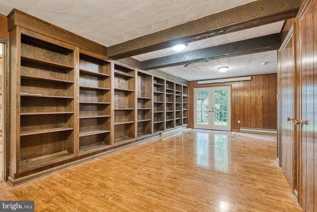 7423 Round Hill Rd, Frederick, MD 21702 - empty room with french doors, wooden walls, light wood-style floors, beam ceiling, and a baseboard heating unit