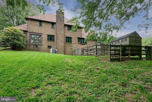 7423 Round Hill Rd, Frederick, MD 21702 - back of property featuring brick siding, a chimney, and central AC unit