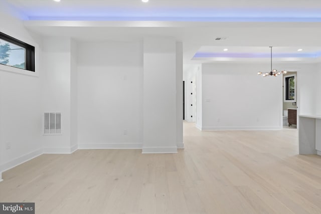 2007 S Joyce St, Arlington, VA 22202 - spare room featuring a chandelier, recessed lighting, light wood-style flooring, a raised ceiling, and baseboards