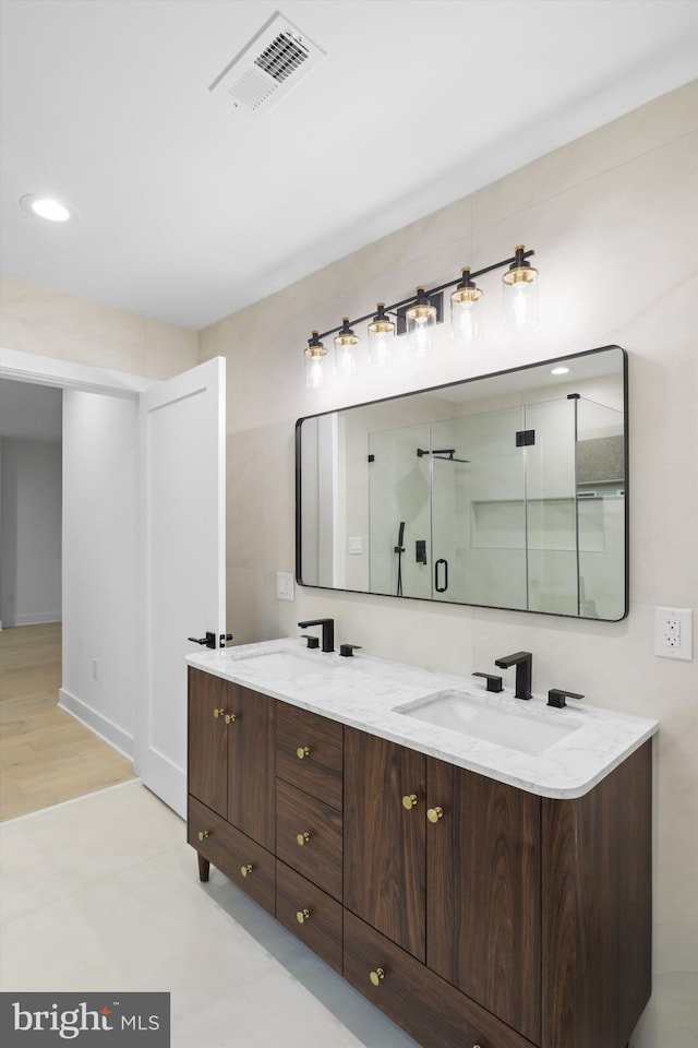 2007 S Joyce St, Arlington, VA 22202 - bathroom with double vanity, baseboards, a shower with shower door, and recessed lighting