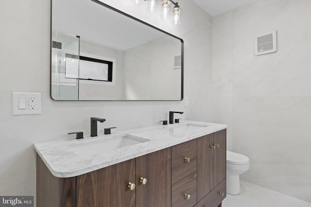 2007 S Joyce St, Arlington, VA 22202 - bathroom featuring double vanity, toilet, and a shower