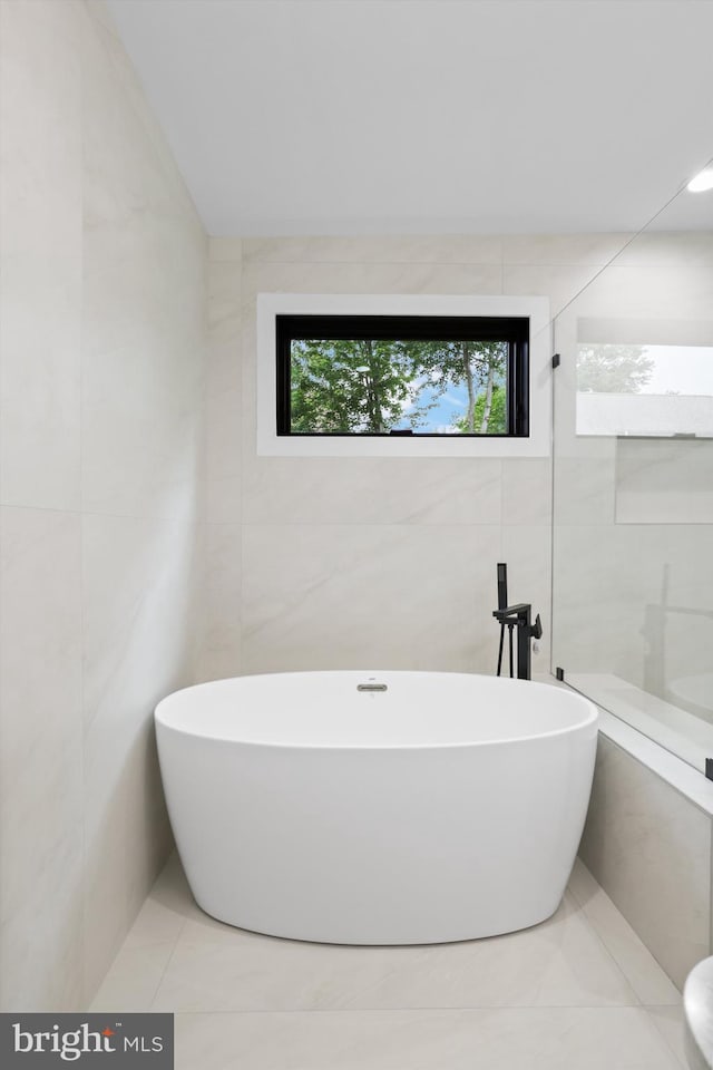 2007 S Joyce St, Arlington, VA 22202 - full bath with tile walls, a freestanding tub, and tile patterned floors