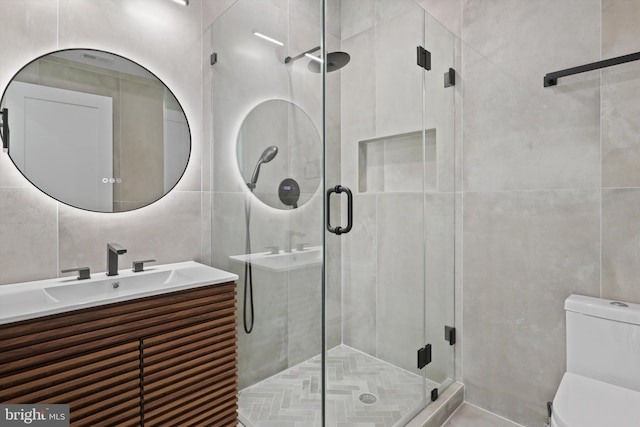 2007 S Joyce St, Arlington, VA 22202 - bathroom with tile walls, vanity, toilet, and a shower stall