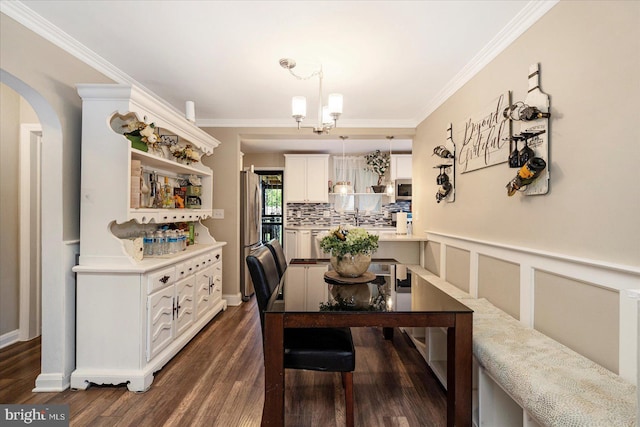 4406 Furley Ave, Baltimore, MD 21206 - dining room with arched walkways, dark wood-style flooring, and crown molding