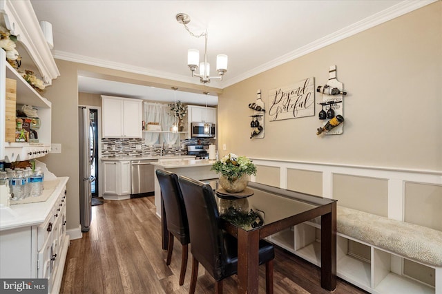 4406 Furley Ave, Baltimore, MD 21206 - dining room with a chandelier, ornamental molding, wood finished floors, and a wainscoted wall