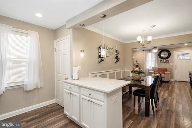 4406 Furley Ave, Baltimore, MD 21206 - kitchen with dark wood-type flooring, white cabinets, a peninsula, open floor plan, and crown molding
